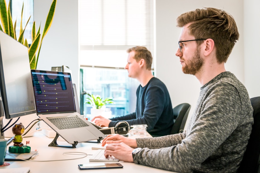 Person working on laptop in a shared office environment
