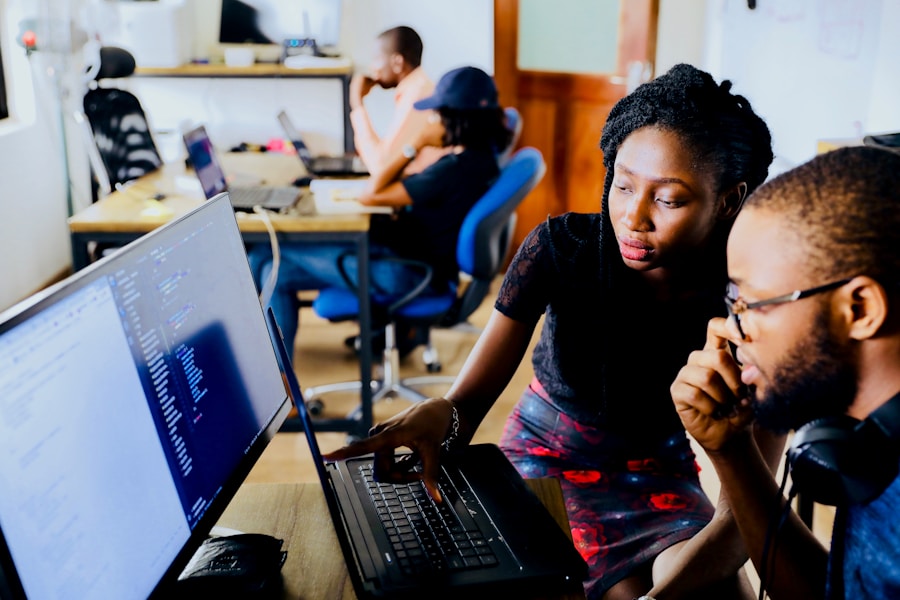 Instructor guiding an adult learner through computer software