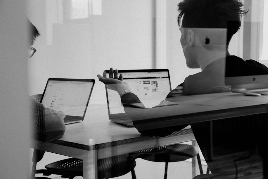 Professional reviewing freelance project documents on laptop